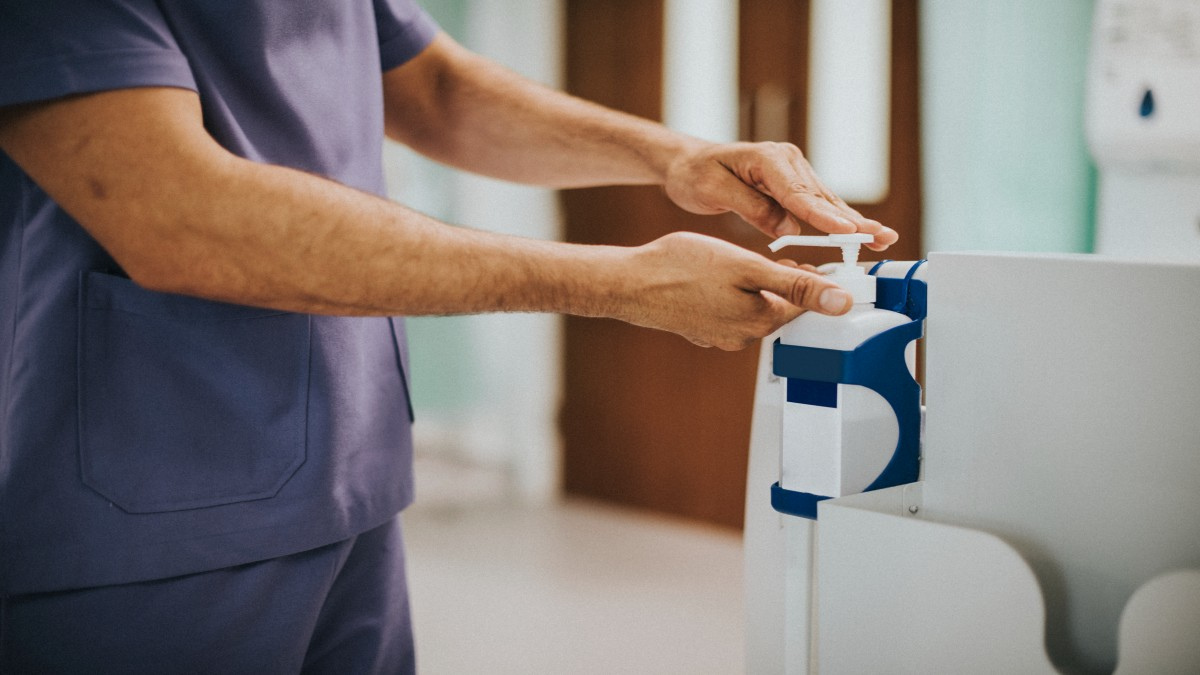Using hand sanitizer dispenser